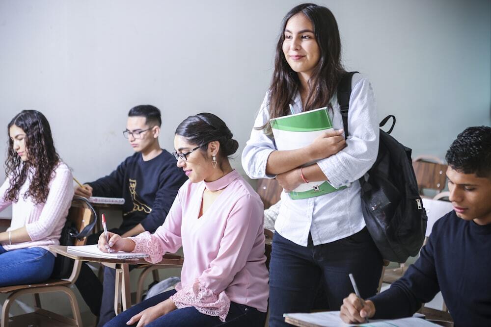 A student walking through a classroom